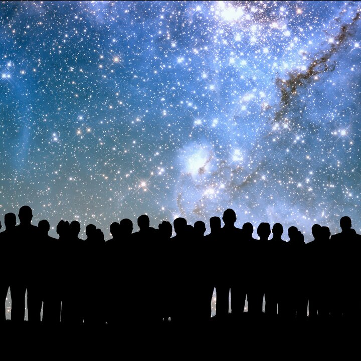 Personengruppe abgebildet vor dem Nachthimmel mit Sternen und Galaxien